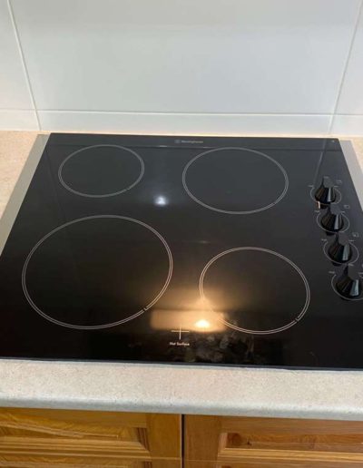 Cooktop install with stainless steel strips on each side - in a suburban Adelaide home