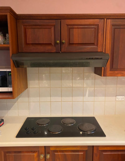 Before & after photos of replacing old solid hotplates with a new Westinghouse ceramic cooktop.